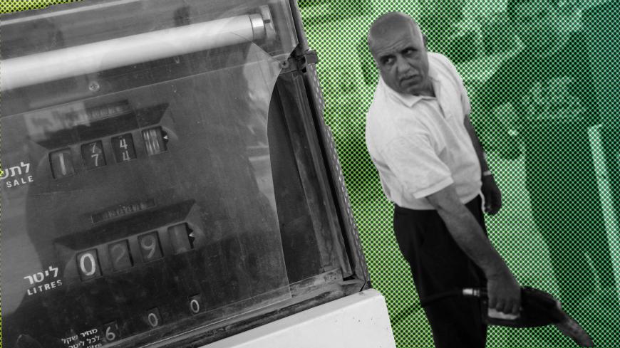 HAWARRA, WEST BANK - MAY 11:  Palestinian gas station manager Hammad Damedi fills 18-liter plastic containers with 96-octane petrol as his fuel stocks are on the point of running out May 11, 2006 in the West Bank village of Hawarra. Petrol stations across the West Bank and the Gaza Strip began closing their pumps after their Israeli supplier cut off deliveries over the Palestinian government's failure to pay its fuel bills. (Photo by David Silverman/Getty Images)