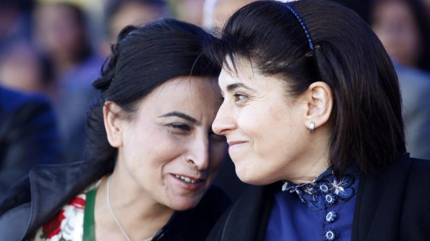 Pro-Kurdish former lawmakers Leyla Zana (R) and Aysel Tugluk who were banned from politics attend a gathering to celebrate Newroz in the southeastern Turkish city of Diyarbakir March 21, 2010. Newroz, which means "new day" in Kurdish, marks the arrival of spring and is also celebrated in Afghanistan, Azerbaijan, Iran, and Tajikistan. Newroz has long served as a rallying cry for Kurdish nationalism and public celebrations were illegal in Turkey until 2000, when fighting between security forces and separatist