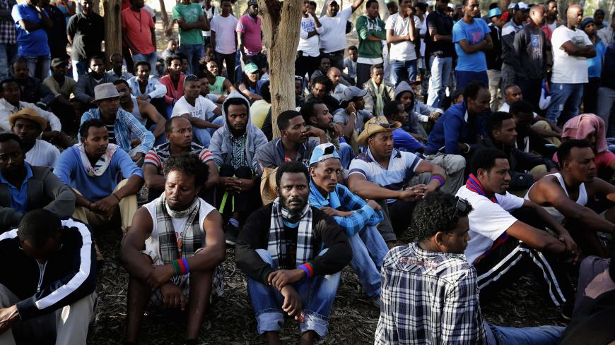 African asylum seekers gather for a morning meeting during an overnight protest after leaving Holot open detention centre in southern Israel's Negev desert, June 28, 2014. Israel opened Holot as part of its bid to rid itself of some of the 50,000 African migrants, mostly Sudanese and Eritreans, who have entered its territory illegally since around 2007. Several hundred asylum seekers attempted on Friday to march to the nearby border with Egypt, where they hoped to bring international attention to their stru