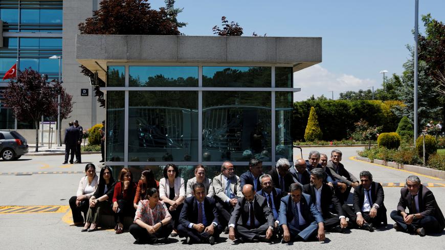 Pro-Kurdish Peoples' Democratic Party (HDP) lawmakers hold a sit-in to protest against detention of lawmakers, outside the Constitutional Court in Ankara, Turkey June 16, 2017. REUTERS/Umit Bektas - RC16564D3C40