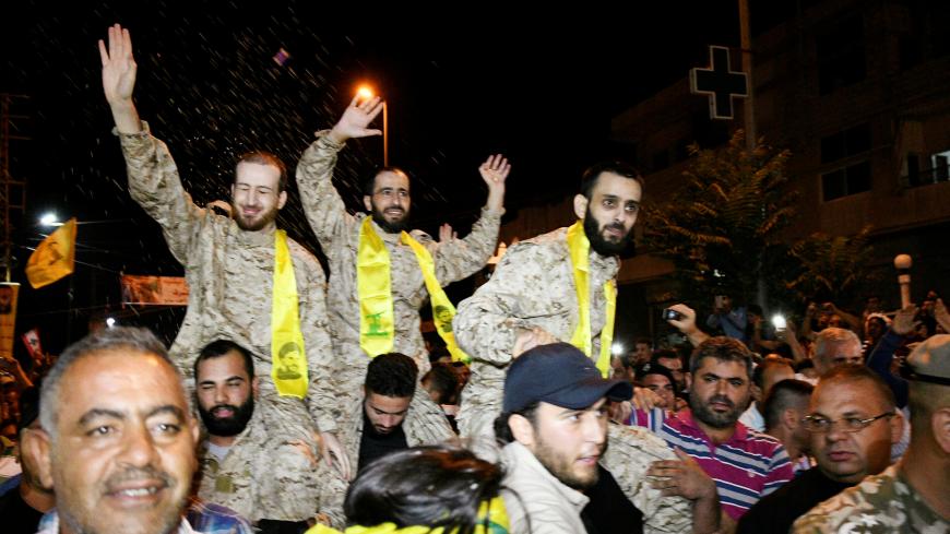 Hezbollah members celebrate in Qaa, Lebanon, after being released by Nusra Front, August 3, 2017. REUTERS/ Hassan Abdallah - RC1698FCD5E0
