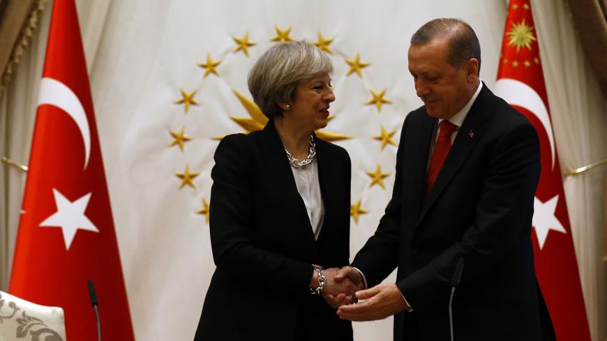 Turkish President Tayyip Erdogan shakes hands with Britain's Prime Minister Theresa May after their meeting at the Presidential Palace in Ankara, Turkey, January 28, 2017. REUTERS/Umit Bektas - LR1ED1S12NA6O