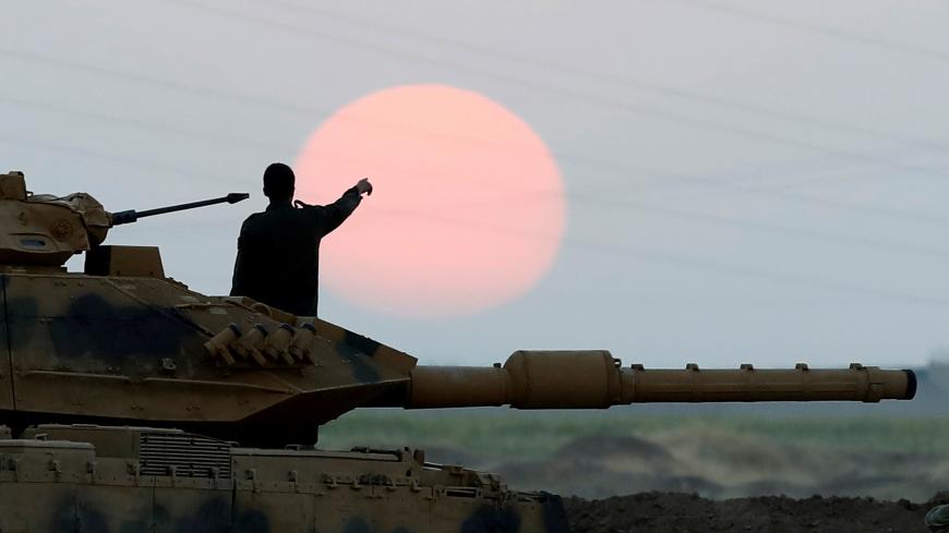 A Turkish soldier points as he stands on a tank during a military exercise near the Turkish-Iraqi border in Silopi, Turkey, September 22, 2017. REUTERS/Umit Bektas     TPX IMAGES OF THE DAY - RC1DFB08C2A0