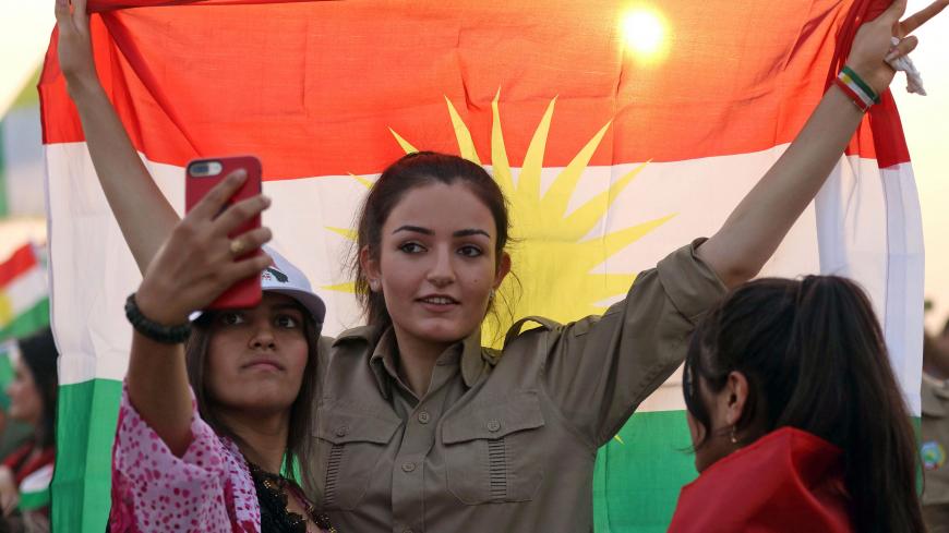 An Iranian Kurdish woman holds a Kurdish flag as she takes part in a gathering to urge people to vote in the upcoming independence referendum in the town of Bahirka, north of Arbil, the capital of the autonomous Kurdish region of northern Iraq, on September 21, 2017.
The controversial referendum on independence for Iraqi Kurdistan is set for September 25. / AFP PHOTO / SAFIN HAMED        (Photo credit should read SAFIN HAMED/AFP/Getty Images)
