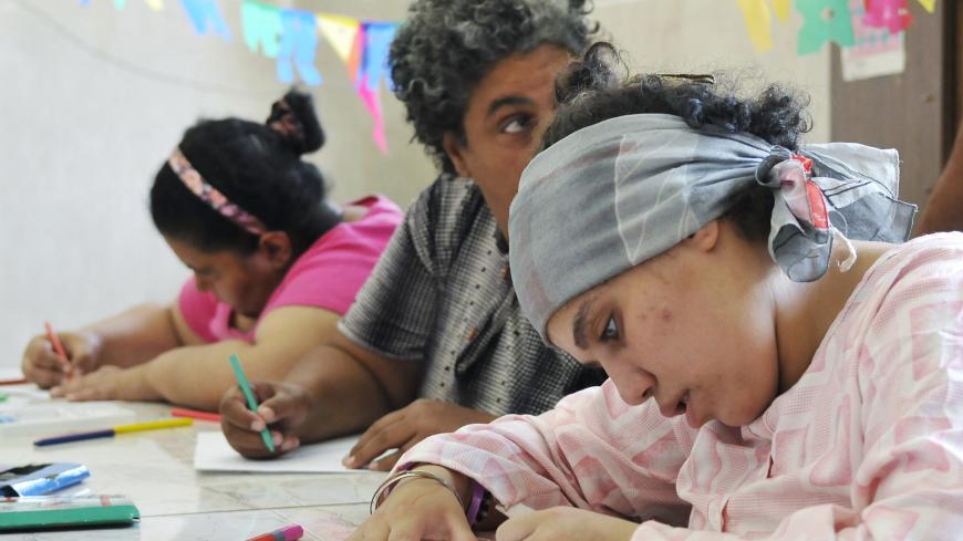 Patients at the Hospital for Mental Health in Al-Abassiya of Cairo draw during an art lesson as part of a treatment program which works on strengthening their abilities to integrate into society August 5, 2010. The hospital has around 1,500 patients from all over the governorates in Egypt, according to hospital staff. REUTERS/Mohamed Abd El-Ghany (EGYPT - Tags: HEALTH SOCIETY) - GM1E6851Q8I01