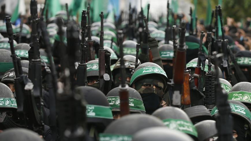 Palestinian members of al-Qassam Brigades, the armed wing of the Hamas movement, take part in a military parade marking the 27th anniversary of Hamas' founding, in Gaza City December 14, 2014.  REUTERS/Mohammed Salem (GAZA - Tags: POLITICS MILITARY ANNIVERSARY) - GM1EACE1NB801
