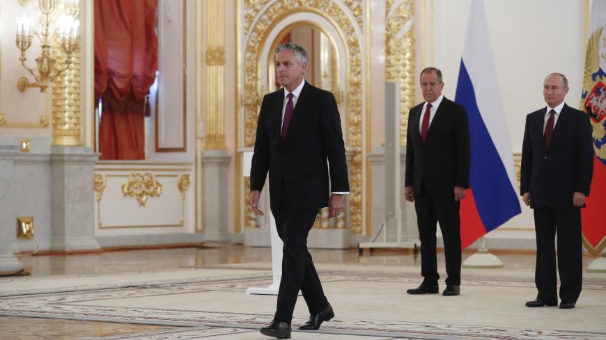 Russian President Vladimir Putin (R) looks at Jon Huntsman, the U.S. new ambassador to Russia, who walks after presenting his diplomatic credentials, with Russian Foreign Minister Sergei Lavrov (2nd R) seen nearby, during a ceremony at the Kremlin in Moscow, Russia October 3, 2017. REUTERS/Pavel Golovkin/Pool - UP1EDA30VTC0E