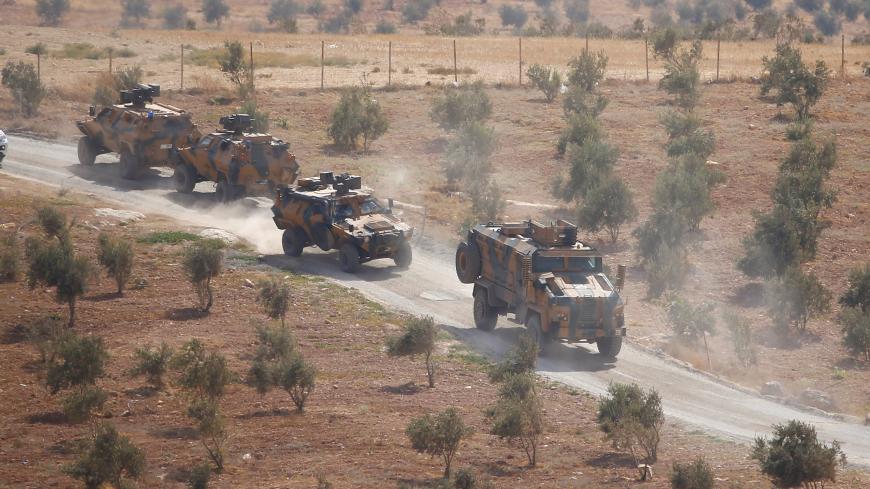 Turkish armoured military vehicles patrol on the Turkish-Syrian border line in Reyhanli, Hatay province, Turkey, October 8, 2017. REUTERS/Osman Orsal - RC19C08D1DE0