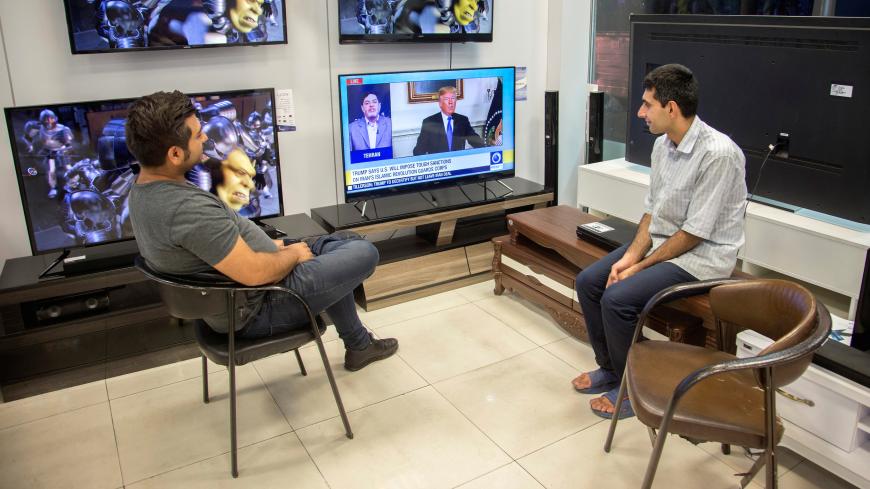 Men watch a television broadcast of U.S. President Donald Trump's speech, in Tehran, Iran October 13, 2017. Nazanin Tabatabaee Yazdi/TIMA via REUTERS ATTENTION EDITORS - THIS IMAGE WAS PROVIDED BY A THIRD PARTY. - RC13A337D430