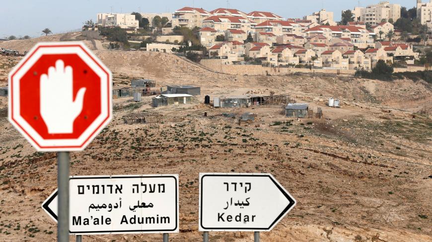 Road signs are seen in front of the Israeli settlement of Maale Adumim in the occupied West Bank, near Jerusalem January 17, 2017. Picture taken January 17, 2017. REUTERS/Ammar Awad - RC1AE87475A0