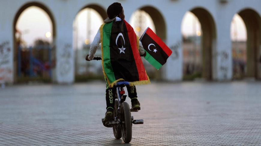 A boy wearing a Libyan flag takes part in a celebration marking the sixth anniversary of the Libyan revolution, in Benghazi, Libya February 17, 2017. REUTERS/Esam Omran Al-Fetori      TPX IMAGES OF THE DAY - RC1CEEEEB180