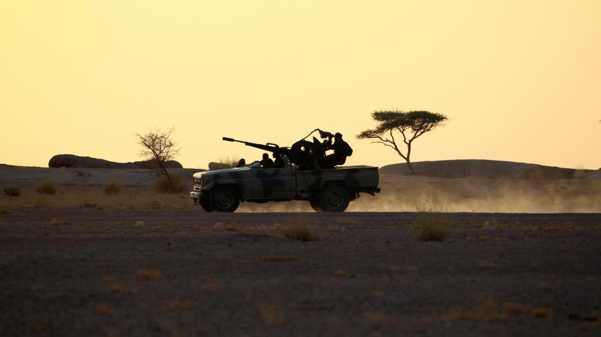 The Polisario Front soldiers drive a pick-up truck mounted with an anti-aircraft weapon during sunset in Bir Lahlou, Western Sahara, September 9, 2016. REUTERS/Zohra Bensemra          SEARCH ìPOLISARIOî FOR THIS STORY. SEARCH "WIDER IMAGE" FOR ALL STORIES.     - S1BEUKRIISAA