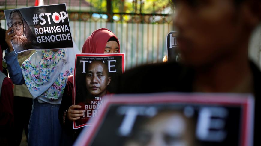 Muslim students holds poster near the Myanmar embassy during a protest against the treatment of the Rohingya Muslim minority by the Myanmar government, in Jakarta, Indonesia September 15, 2017. REUTERS/Beawiharta - RC1F13A51BF0