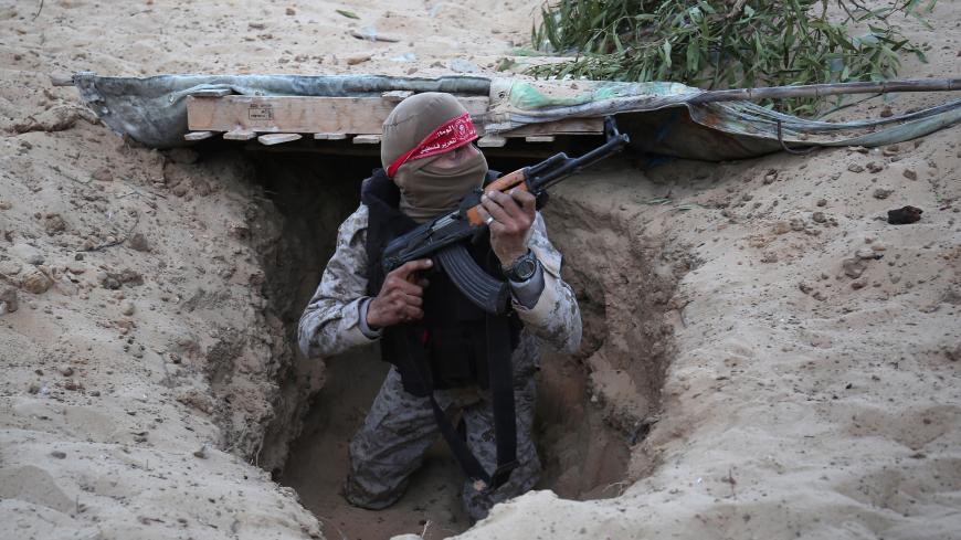 A Palestinian militant of the National Resistance brigades, the armed wing of the Democratic Front for the Liberation of Palestine (DFLP), gets out of a tunnel during a graduation ceremony in Rafah, in the southern Gaza Strip, on November 4, 2016. / AFP / SAID KHATIB        (Photo credit should read SAID KHATIB/AFP/Getty Images)