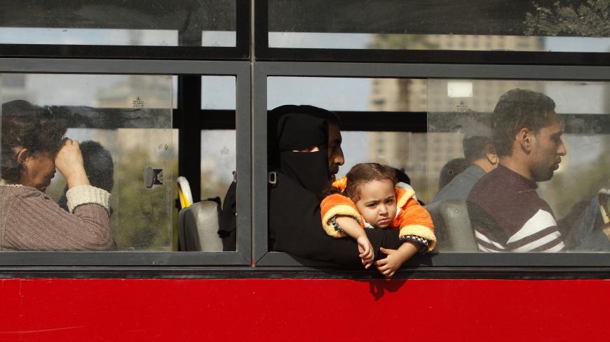 A girl looks out of a window as she rides a bus in Cairo December 17, 2012. REUTERS/Khaled Abdullah (EGYPT - Tags: SOCIETY) - GM1E8CH1P0501