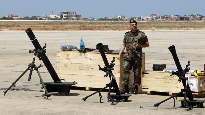 A Lebanese Army soldier walks past displayed weapons donated by the U.S. government to the Lebanese army, during a ceremony at Beirut international airport August 29, 2014. REUTERS/ Mohamed Azakir  (LEBANON - Tags: MILITARY POLITICS) - GM1EA8T1IWS01