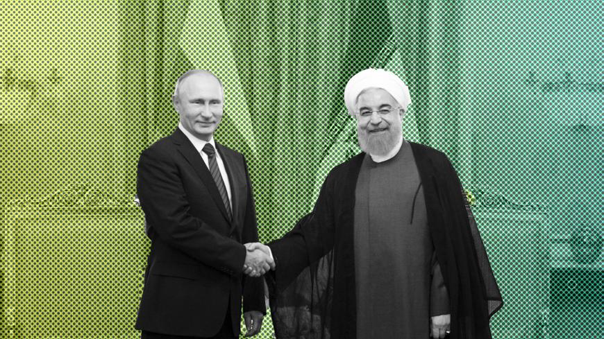 Russian President Vladimir Putin (L) shakes hands with his Iranian counterpart Hassan Rouhani during a meeting in Tehran, Iran November 1, 2017.  Sputnik/Alexei Druzhinin/Kremlin via REUTERS  ATTENTION EDITORS - THIS IMAGE WAS PROVIDED BY A THIRD PARTY. - UP1EDB10X4U08