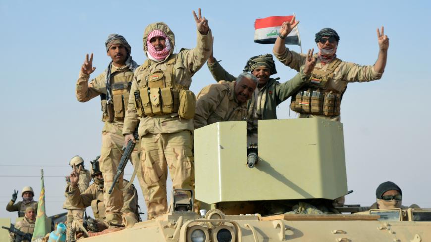Iraqi forces show victory signs after they captured Rawa town, the last remaining town under Islamic State control, Iraq November 17, 2017. REUTERS/Stringer - RC16EFE59700