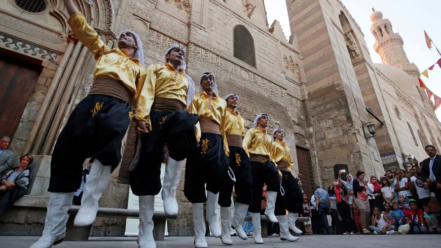 Members of an Arabian group perform a traditional Dabke folk dance during the African-Chinese cultural festival, organised by Egypt's Ministry of Tourism, on the historic Moez Street, in Cairo, Egypt July 25, 2016. Picture taken July 25, 2016. REUTERS/Amr Abdallah Dalsh - D1BETSEAVPAA