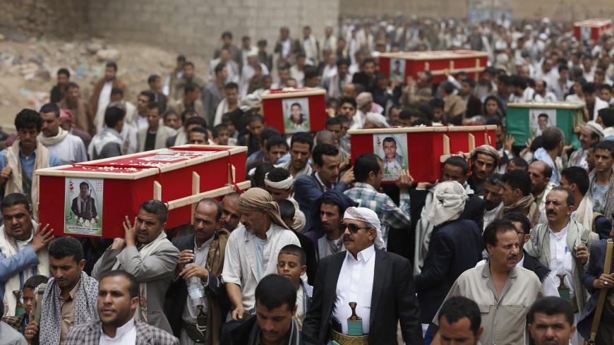 Houthi followers carry coffins of those killed in a car blast attack on Monday, and a Houthi fighter who was killed during fighting in Yemen's southern port city of Aden, in Sanaa July 22, 2015. Five people were killed in the blast that hit the Moeed mosque in Sanaa, which is used by the Houthis, police sources said. Islamic State's Yemen branch claimed responsibility for the attack, in which seven others were wounded. REUTERS/Khaled Abdullah - GF10000166909