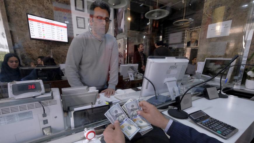 A money changer counts out U.S. dollars for a customer in Tehran's business district, Iran, January 20, 2016. REUTERS/Raheb Homavandi/TIMA  ATTENTION EDITORS - THIS IMAGE WAS PROVIDED BY A THIRD PARTY. FOR EDITORIAL USE ONLY.   - GF20000100973