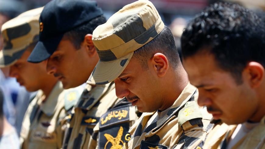 Egyptian army officers react during the funeral of officer Khaled al-Maghrabi, who was killed during a suicide bomb attack on an army checkpoint in Sinai, in his hometown Toukh, Al Qalyubia Governorate, north of Cairo, Egypt 8 July, 2017. REUTERS/Mohamed Abd El Ghany - RC15CBC45300