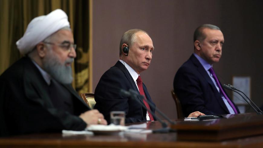 Iran's President Hassan Rouhani together with his counterparts, Russia's Vladimir Putin and Turkey's Tayyip Erdogan, attend a joint news conference following their meeting in Sochi, Russia November 22, 2017. Sputnik/Mikhail Klimentyev/Kremlin via REUTERS ATTENTION EDITORS - THIS IMAGE WAS PROVIDED BY A THIRD PARTY. - RC1D16F4FF70