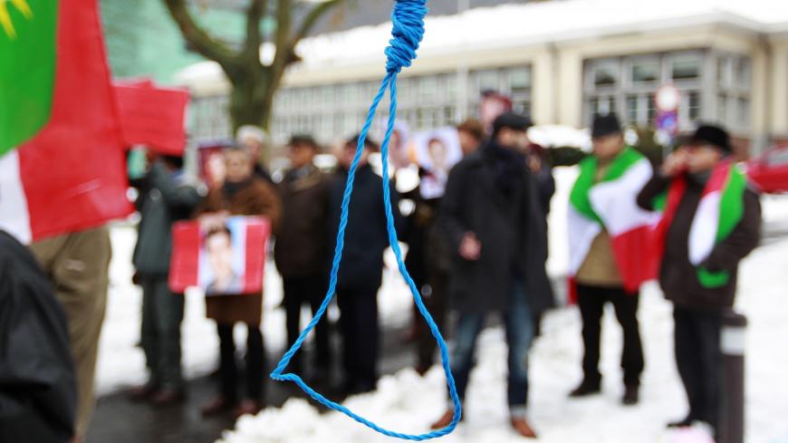 Iranian exiles shout slogans in front of a mock gallows to protest against executions in Iran during a demonstration outside the Iranian embassy in Brussels December 29, 2010.   REUTERS/Francois Lenoir (BELGIUM - Tags: CIVIL UNREST POLITICS) - GM1E6CT1T7M01