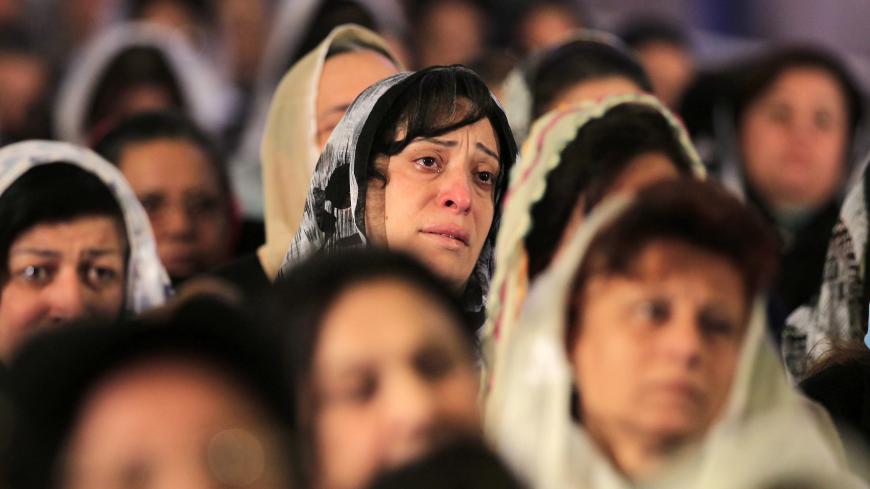 Coptic Christian women attend the Coptic mass prayers for the Egyptians beheaded in Libya, at Saint Mark's Coptic Orthodox Cathedral in Cairo, February 17, 2015. Egyptian President Abdel Fattah Al-Sisi called for a United Nations resolution mandating an international coalition to intervene in Libya after Egypt's airforce bombed Islamic State targets there.  Egypt directly intervened for the first time in the conflict in neighbouring Libya on Monday after an Islamic State group in the country released a vide