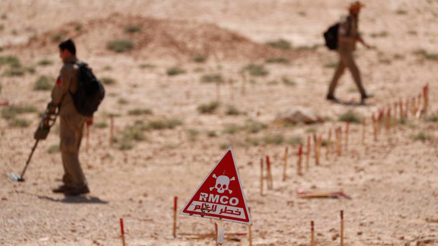 Members of Roj Mine Control Organization search for mines and explosive devices planted by Islamic State militants to disarm them near Ain Issa village north of Raqqa, Syria, June 20, 2017. REUTERS/Goran Tomasevic - RC1FCEC4E0B0