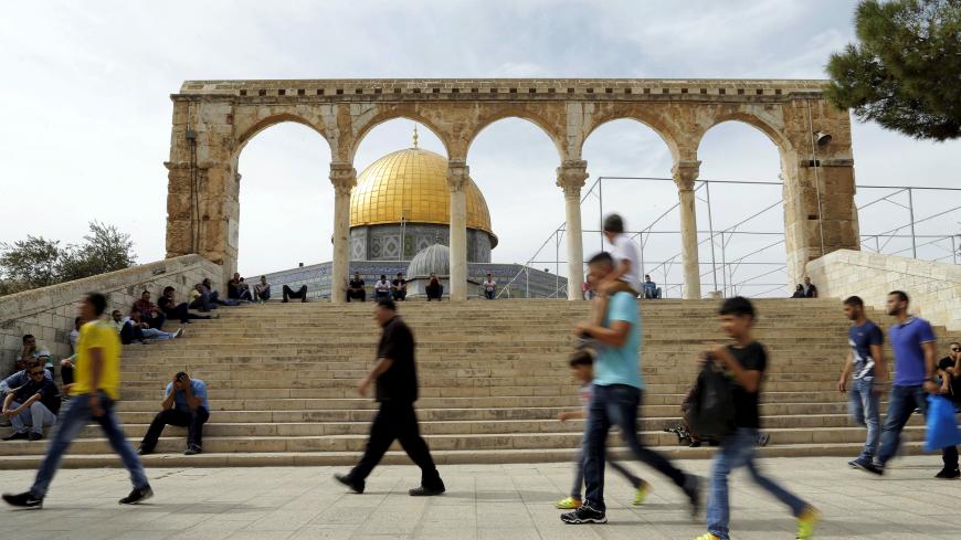 The Dome of the Rock is seen in the background as Palestinians wait for Friday prayers to begin on the compound known to Muslims as Noble Sanctuary and to Jews as Temple Mount in Jerusalem's Old City October 23, 2015. Palestinian factions called for mass rallies against Israel in the occupied West Bank and East Jerusalem in a "day of rage" on Friday, as world and regional powers pressed on with talks to try to end more than three weeks of bloodshed. Israeli authorities also lifted restrictions on Friday tha