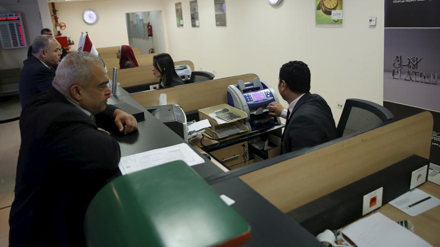Customers are seen at the National Bank of Egypt (NBE), also known as the Al Ahli Bank in Cairo, Egypt  March 10, 2016. REUTERS/Amr Abdallah Dalsh - GF10000340456