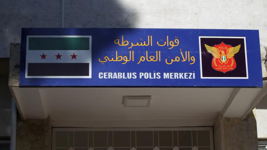 A sign showing the Free Syrian army flag (L) and a logo of the "Free Police" is seen in the Syrian border town of Jarablus January 24, 2017. The text reads in Arabic(top) :"National general security and police force". REUTERS/Khalil Ashawi - RC161F274C90