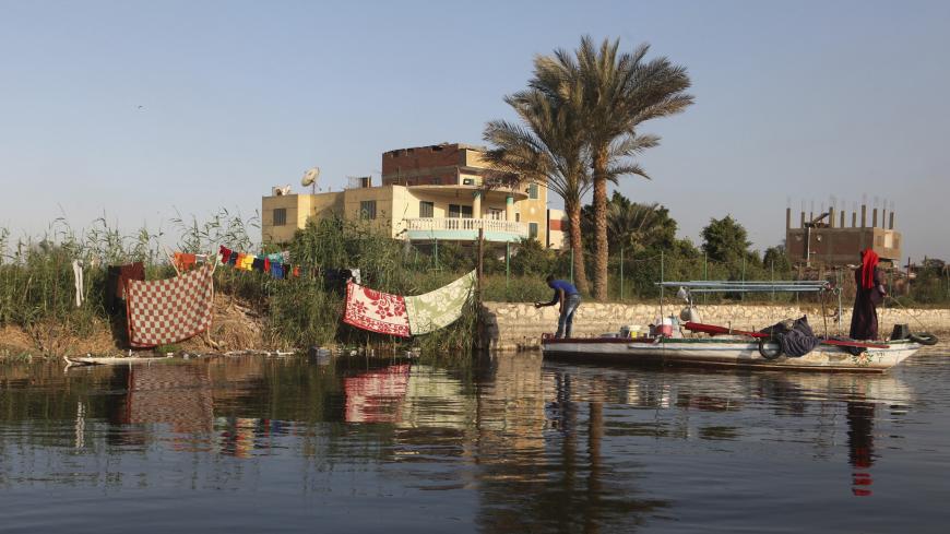 Fishermen hang their clothes out to dry on the banks of the river Nile in Cairo April 16, 2013. REUTERS/Asmaa Waguih (EGYPT) - LM2E96J0YTF01