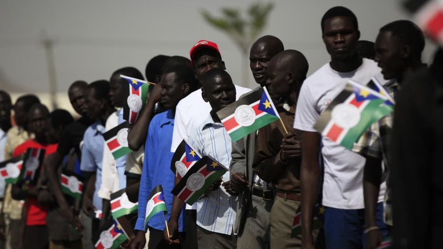Men wait in line to get inside a hall during a rally for the Sudan's People Liberation Movement (SPLM) youth in Juba, February 15, 2014. REUTERS/Andreea Campeanu (SOUTH SUDAN - Tags: POLITICS) - GM1EA2F1IE101