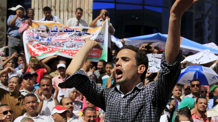 Staff and workers of Egypt's Ministry of Finance Tax Authority shout slogans against Finance Minister Hany Kadry Dimian and the government during a protest in front of the Syndicate of Journalists in Cairo, August 10, 2015. Trade union workers staged the protest to demand the abolition of the Civil Service Law and a minimum and a maximum wage for public servants, local media reported.  REUTERS/Amr Abdallah Dalsh - GF20000019149