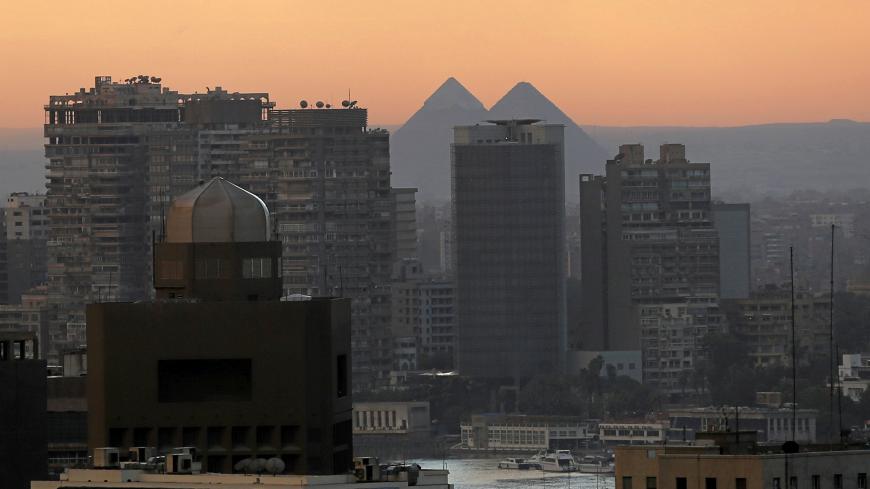 The Giza Pyramids are pictured behind the River Nile, houses and hotels on a cold day around in Cairo, Egypt December 5, 2016.  REUTERS/Amr Abdallah Dalsh - RC163ED1B870