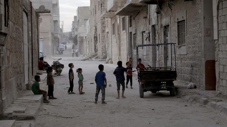 Children play along a street on the southern outskirts of the Syrian city of al-Bab, Syria September 16, 2017. Picture taken September 16, 2017. REUTERS/Khalil Ashawi - RC1E136FE550