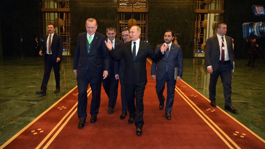 Russian President Vladimir Putin (C, front) and Turkish President Tayyip Erdogan (L, front) walk during a meeting in Ankara, Turkey December 11, 2017.  Sputnik/Alexei Druzhinin/Sputnik via REUTERS  ATTENTION EDITORS - THIS IMAGE WAS PROVIDED BY A THIRD PARTY. - UP1EDCB1EWG4D