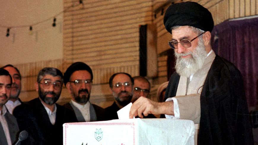 Ayatollah Ali Khamenei, Iran's spiritual guide, casts his ballot at the Imam Khomeiny mosque in Tehran, 26 February, during the country's first municipal elections since the 1979 Islamic revolution. The elections for some 200,000 seats on municipal councils across the country are seen as an important yardstick of social changes set in train by reformist President Mohamad Khatami.  (Photo credit should read ATTA KENARE/AFP/Getty Images)