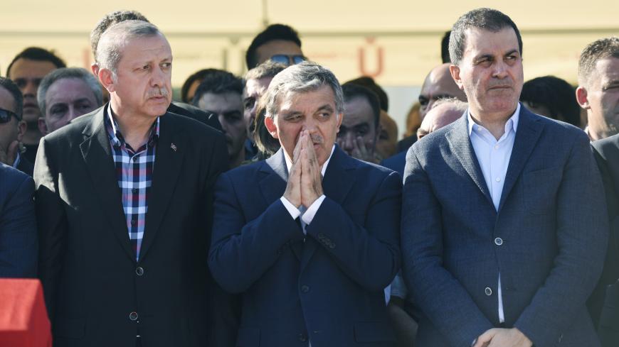 Turkey's President Recep Tayyip Erdogan (L) and former Turkish president Abdullah Gul (C) react after attending the funeral of a victim of the coup attempt in Istanbul on July 17, 2016. 
Turkish President Recep Tayyip Erdogan vowed today to purge the "virus" within state bodies, during a speech at the funeral of victims killed during the coup bid he blames on his enemy Fethullah Gulen. / AFP / BULENT KILIC        (Photo credit should read BULENT KILIC/AFP/Getty Images)