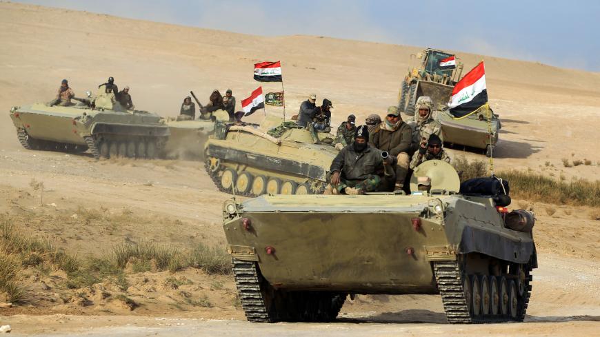 Armoured personnel carriers (APCs) of the Iraqi forces and the Hashed al-Shaabi (Popular Mobilisation units) advance through Anbar province, 20 kilometres east of the city of Rawah in the western desert bordering Syria, on November 25, 2017, in a bid to flush out remaining Islamic State (IS) group fighters in the al-Jazeera region. / AFP PHOTO / AHMAD AL-RUBAYE        (Photo credit should read AHMAD AL-RUBAYE/AFP/Getty Images)
