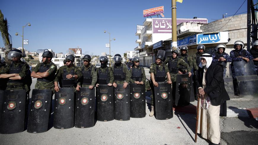 Members of Palestinian security forces stand guard during a rally in support of Palestinian journalist Mohammad al-Qiq, who was detained by Israel in November and was on a hunger strike to protest his detention without charge, in the West Bank city Ramallah February 26, 2016. Al-Qiq, accused by Israel of being a Hamas activist and held without charge has agreed to end his three-month long hunger strike, his family and lawyers said on Friday. REUTERS/Mohamad Torokman  - GF10000324491