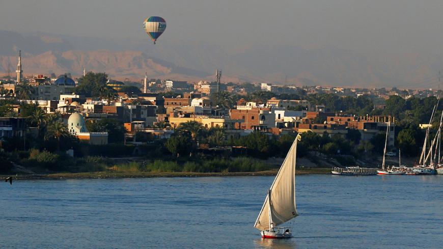 A balloon is seen above the Nile River as boats wait for tourists in the port city of Luxor, south of Cairo, Egypt December 14, 2016. Picture taken December 14, 2016. REUTERS/Amr Abdallah Dalsh - RC155D167990
