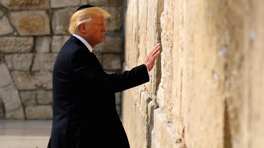 U.S. President Donald Trump prepares to leave a note at the Western Wall in Jerusalem May 22, 2017.  REUTERS/Jonathan Ernst - RC193CE34530