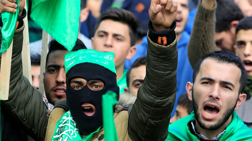 Palestinian Hamas supporters shout slogans during a rally marking the 30th anniversary of Hamas' founding, in the West Bank city of Nablus December 15, 2017. REUTERS/Abed Omar Qusini - RC118A3024A0