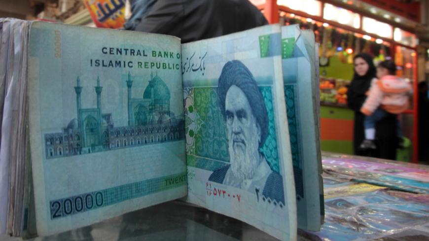An Iraqi money dealer counts Iranian rial banknotes bearing a portrait of the late founder of the Islamic Republic of Iran, Ayatollah Ruhollah Khomeini, at an exchange office in Baghdad on February 3, 2012. Tens of thousands of Iranian visitors have been finding difficulty in using the Iranian currency in Iraq due to a depreciation of the rial against the dollar. AFP PHOTO/ ALI AL-SAADI (Photo credit should read ALI AL-SAADI/AFP/Getty Images)