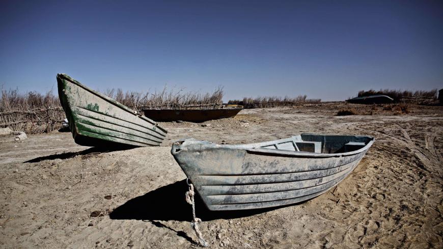 Abandoned boats in Sikh Sar village at Hamoon wetland near the Zabol town, in southeastern province of Sistan-Baluchistan bordering Afghanistan on February 2, 2015. AFP PHOTO/BEHROUZ MEHRI        (Photo credit should read BEHROUZ MEHRI/AFP/Getty Images)