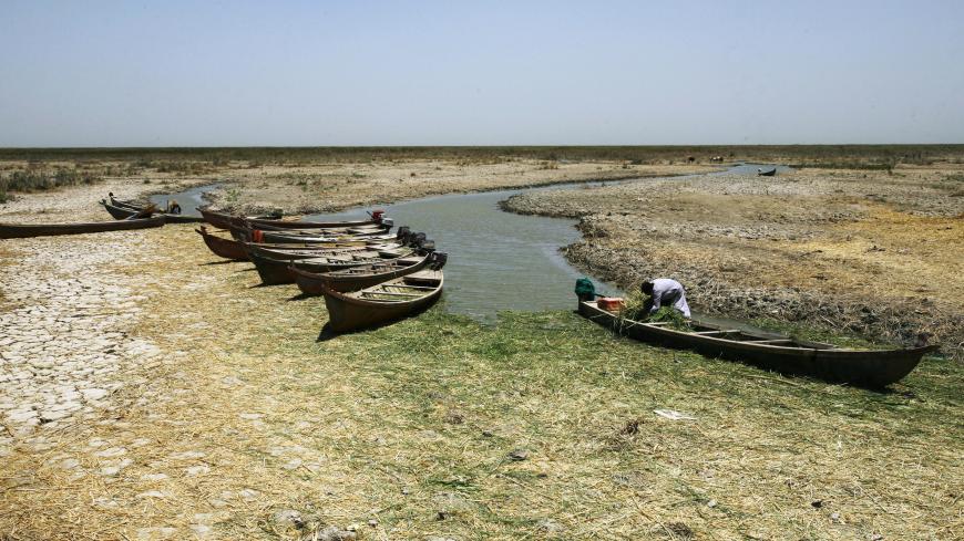 Canoes are seen in the shallow waters of the Chibayish marshes near the southern Iraqi city of Nasiriyah on June 25, 2015. Marsh areas in southern Iraq have been affected since the Islamic State group started closing the gates of a dam on the Euphrates River in the central city of Ramadi, which is under the jihadist group's control. AFP PHOTO / HAIDAR HAMDANI        (Photo credit should read HAIDAR HAMDANI/AFP/Getty Images)