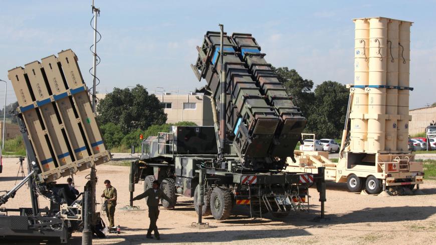 Israeli soldiers walk near an Israeli Irone Dome defence system (L), a surface-to-air missile (SAM) system, the MIM-104 Patriot (C), and an anti-ballistic missile the Arrow 3 (R) during Juniper Cobra's joint exercise press briefing at Hatzor Israeli Air Force Base in central Israel, on February 25, 2016.
Juniper Cobra, is held every two years where Israel and the United States train their militaries together to prepare against possible ballistic missile attacks, as well as allowing the armies to learn to be
